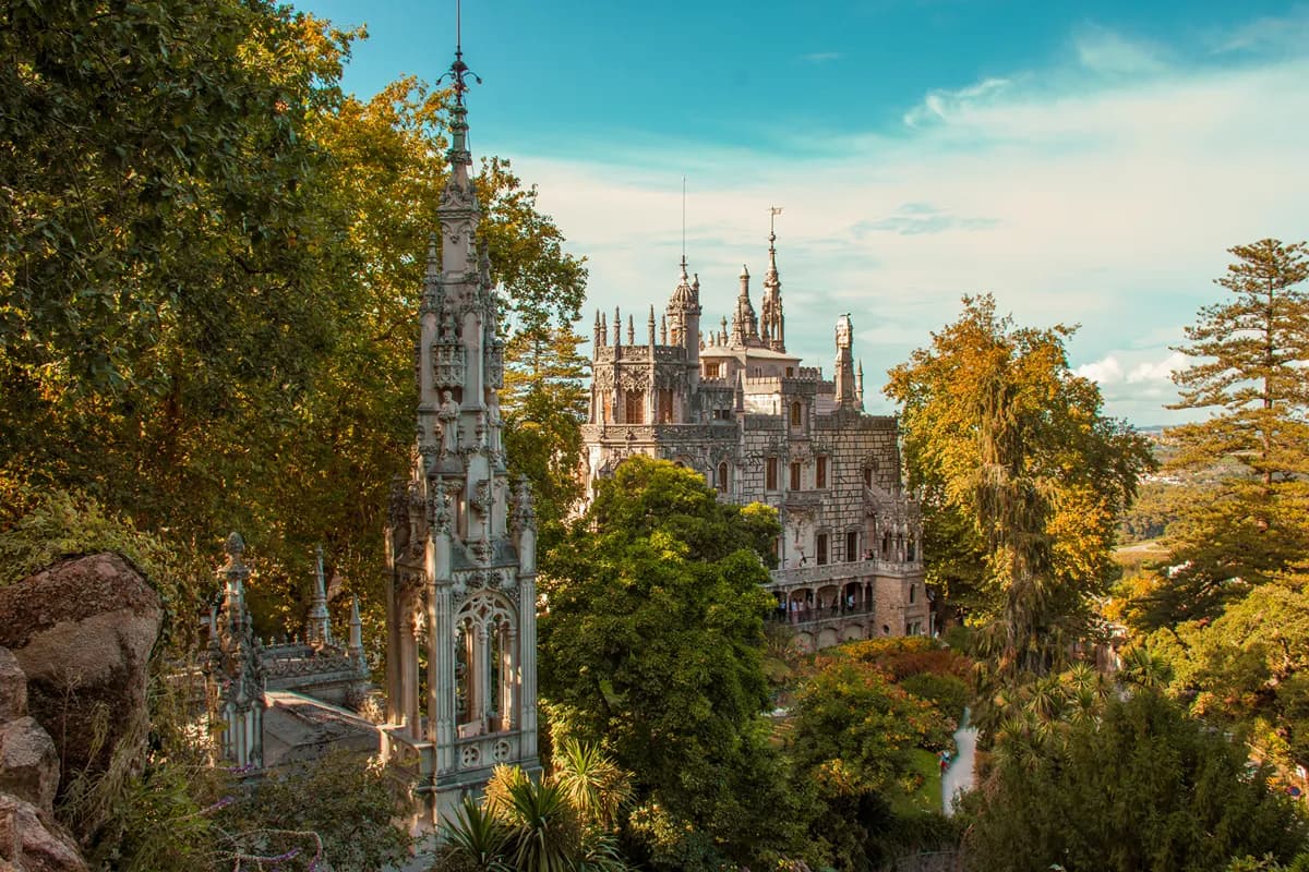 Autumn foliage surrounding a historic palace in Sintra, Portugal.