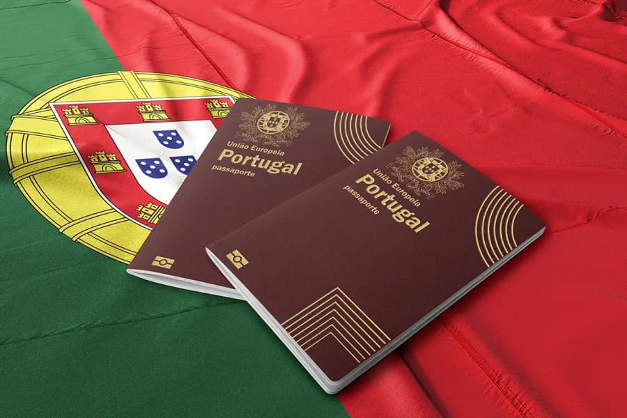Two Portuguese passports lying on a Portuguese flag