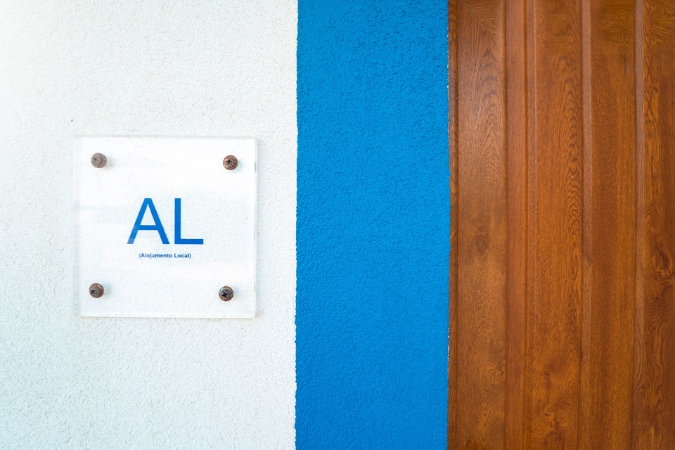 Short term renting AL sign closeup in a Portuguese Building.
