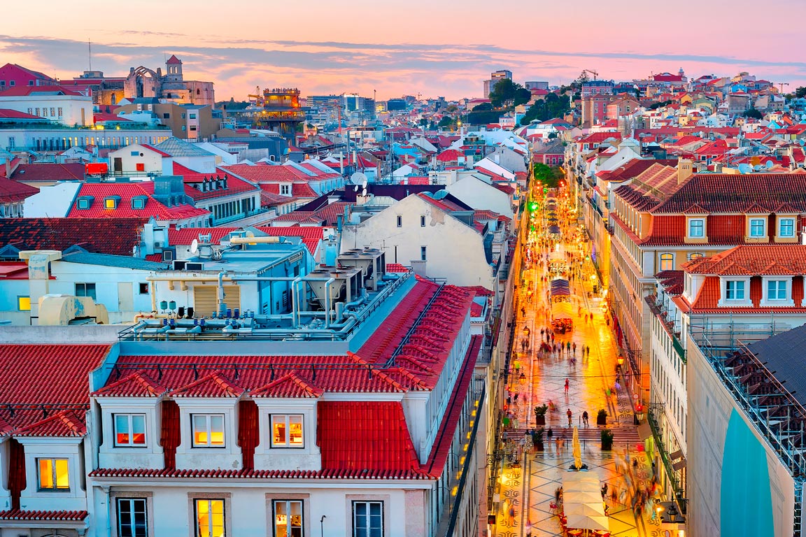 Sunset in the Lisbon City Centre & pedestrians walking along a shopping street.