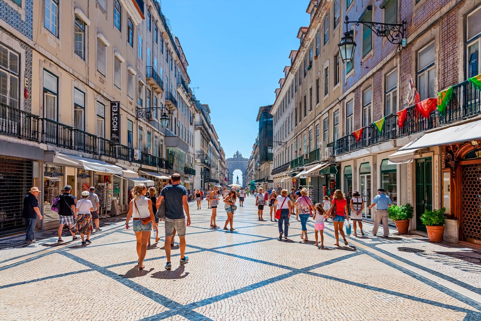 Tourists strolling through Rua Augusta in Lisbon on a hot day.
