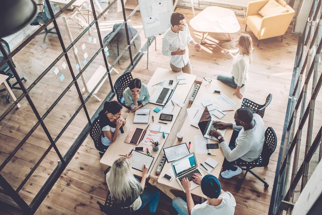 Group of digital nomads working together in a co-working space.