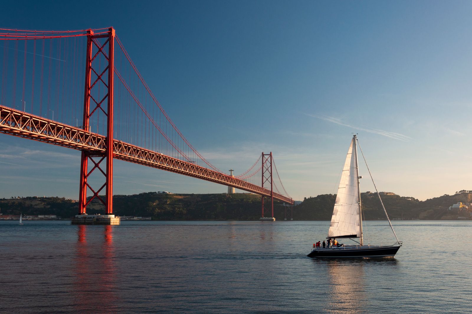 Panorama of Lisbon's river and its famous bridge in the late summer evening,